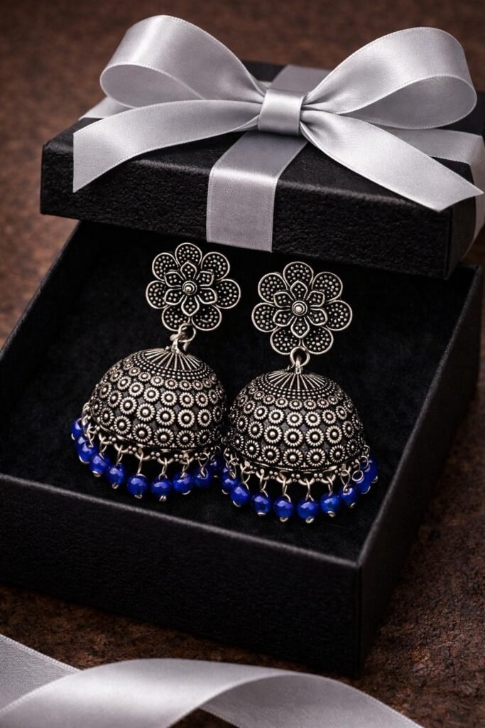 Silver-tone dome jhumka earrings with deep blue beaded border